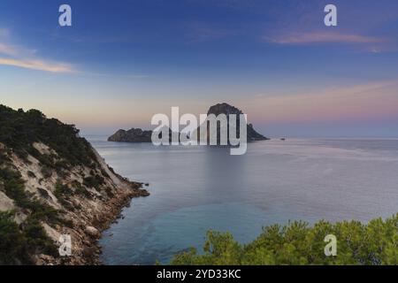 Ein Blick auf das Wahrzeichen der Insel es Vedra und die Felsen vor der Küste von Ibiza bei Sonnenaufgang Stockfoto