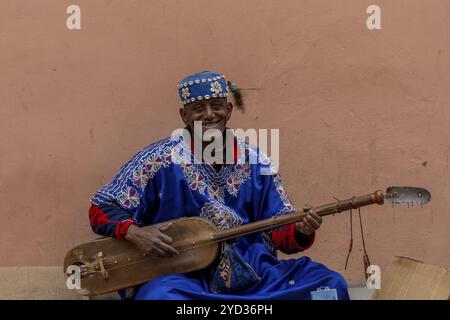 Marrakesch, Marokko, 23. März 2024: Straßenmusiker, der in der Innenstadt von Marrakesch ein westafrikanisches Xalam spielt Stockfoto