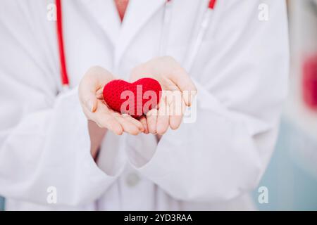 Großaufnahme Arzt Hand mit rotem Herzen singen Symbol für Gesundheit schützen, Pflege und Spende für die Rettung von Menschen Leben. Stockfoto