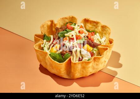 Taco-Salat in Tortilla-Schüssel mit Rind, Käse, Mais und Salat. Stockfoto