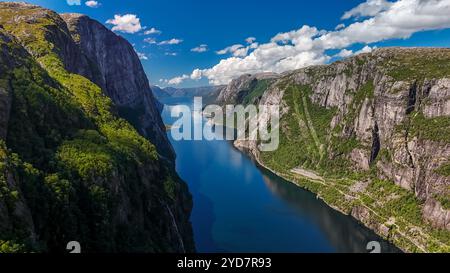 Kjerag, Lysefhjord, Norwegen, Ein Panoramablick auf einen Fjord in Norwegen, mit hohen Klippen, üppigem Grün und einem ruhigen, blauen Hintergrund Stockfoto