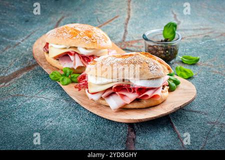 Traditionelle New Orleans Muffaletta-Sandwiches mit Mortadella, Salami und Provolone-Käse serviert in einem italienischen Ciabatta-Brot als Nahaufnahme auf einem Holz Stockfoto