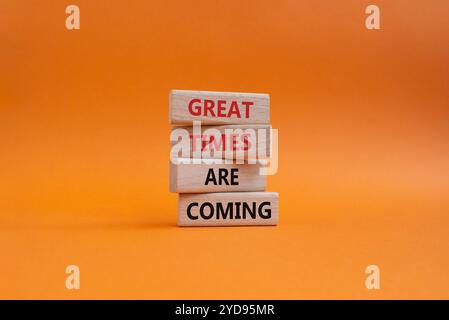 Große Zeiten werden bald Symbol. Concept Words tolle Zeiten kommen auf Holzblöcken. Wunderschöner orangefarbener Hintergrund. Das Geschäft und die großartigen Zeiten kommen Stockfoto