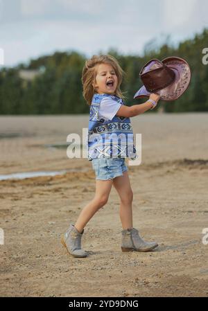 Charmantes Kind im Cowboykostüm auf einer Kuhfarm in Dänemark Stockfoto