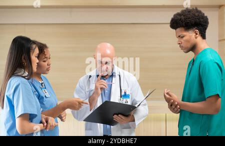 Ein Medizinprofessor berät die praktizierenden Medizinstudenten bei Patientenuntersuchungen Stockfoto