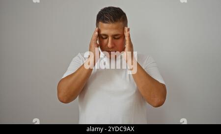 Junger hispanischer Mann in weißem Hemd mit Kopfschmerzen isoliert vor weißem Hintergrund Stockfoto