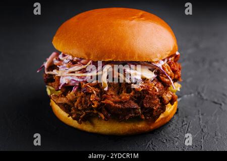 Sandwich mit Pulled Schweinefleisch auf schwarzem Stein Stockfoto