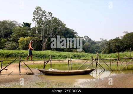 Santarem, Brasilien. November 2023. In Santa Maria do Tapara im brasilianischen Amazonasgebiet überquert Antônio dos Santos einen trockenen Teich. Zwischen September und November 2023 erlebte das Amazonasgebiet eine beispiellose Dürre. Brände verwüsteten Flora und Fauna, und viele Gemeinden waren vom Rest der Welt abgeschnitten, da sie auf ausgetrockneten Wasserstraßen angewiesen sind. (Foto: Apolline Guillerot-Malick/SOPA Images/SIPA USA) Credit: SIPA USA/Alamy Live News Stockfoto