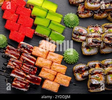 Großes Sushi-Set, von oben auf schwarzem Hintergrund aufgenommen Stockfoto