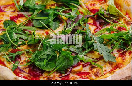 Pizza mit Rucola-Hintergrund Stockfoto