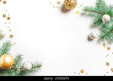 Weihnachtlicher Hintergrund mit Tannenzweigen, goldenen Ornamenten und Sternen, isoliert auf weißem Hintergrund, Kopierraum. Kreatives Weihnachtslayout, Vorlage mit Stockfoto
