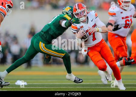 Waco, Texas, USA. Oktober 2024. Der Quarterback ALAN BOWMAN (7) aus Oklahoma State entkommt dem Baylor-Verteidiger STEVE LINTON (10) während seines Spiels im McLane Stadium in Waco am Samstagnachmittag. (Kreditbild: © Brian McLean/ZUMA Press Wire) NUR REDAKTIONELLE VERWENDUNG! Nicht für kommerzielle ZWECKE! Stockfoto