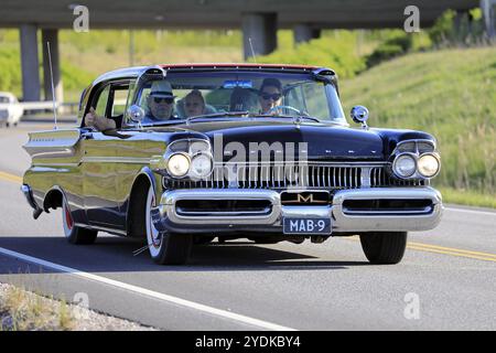 Salo, Finnland. Mai 2019. Familie, die ein klassisches schwarzes Mercury-Auto aus den späten 1950er Jahren auf der Autobahn Salon Maisema fährt und 2019 fährt Stockfoto