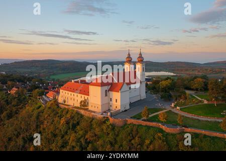 Blick auf die Skyline des berühmten Benediktinerklosters von Tihany (Tihany Abbey) mit wunderschönem farbenfrohen Himmel und Wolken bei Sonnenaufgang. Stockfoto