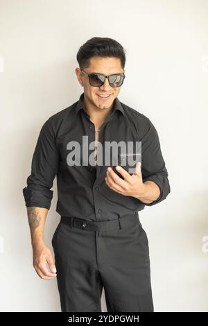 Person, die arbeitet, Handy benutzt junger latino Mann mit kurzen Haaren, Kommunikation und Globalisierung, Geschäftsmann Lebensstil Stockfoto
