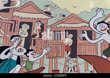 Ein Wandgemälde in der Klong Ong Ang Walking Street in der Gegend von Chinatown/Pahurat in Bangkok, Thailand, das das traditionelle thailändische Dorfleben zwischen Stulthütten darstellt Stockfoto