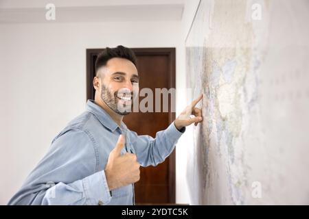 Fröhlicher Latein-Mann, der sich wie ein Daumen hoch vor der Kamera zeigt Stockfoto