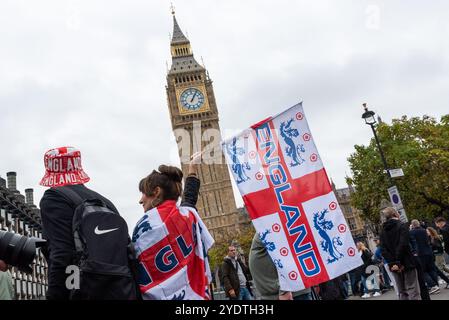 Anhänger von Stephen Yaxley-Lennon (auch bekannt als Tommy Robinson) nehmen an einem protestmarsch nach Whitehall, Großbritannien, Teil. Englands Flagge vor dem Parlament Stockfoto