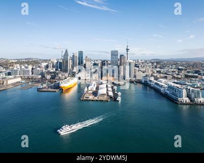 Auckland, Neuseeland - 14. August 2024: Drohnenansicht einer Fähre, die den historischen Fährhafen von Auckland mit der Skyline und einem massiven C verlässt Stockfoto