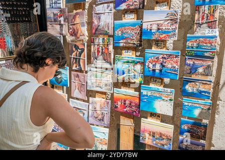 Dubrovnik Kroatien, Altstadt Stari Grad Ragusa ummauerte Stadt, kleine Leinwanddrucke, lokale Szenen, Kunstwerke, Ausstellungsverkauf, Besucher Touristen, Frau aussehende Geschäfte Stockfoto