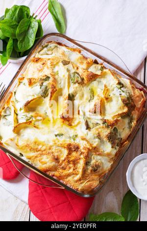 Traditionelle bulgarische oder Balkantorte Banitsa aus Filo-Teig, Frischkäse und Spinat, serviert mit Sahne und Kaffee auf hölzernem Hintergrund. Rustikal Stockfoto