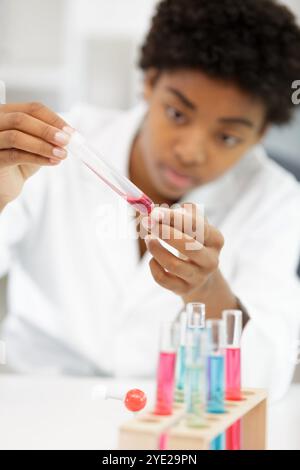 Junge Frau im wissenschaftlichen Labor mit Pipetten und Reagenzgläsern Stockfoto
