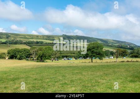 An einem schönen Sommertag entspannen Besucher auf dem Steeple Leaze Campingplatz in Kimmeridge auf der Isle of Purbeck in Dorset. Stockfoto