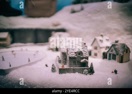 Festliches Weihnachtsdorf mit Miniaturhäusern und schneebedeckten Bäumen Stockfoto