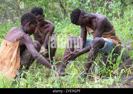 Hadzabe-Jäger, die auf traditionelle Weise in der Nähe des Eyasi-Sees, Tansania, ein Feuer auslösen Stockfoto