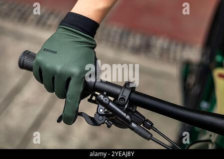 Nahaufnahme einer Hand mit Handschuhen in der Bremsposition Stockfoto