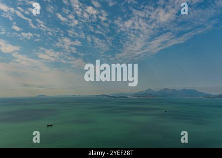 Erleben Sie die bezaubernde Schönheit des Südchinesischen Meeres von Hongkong, wo leuchtende Aquamarin- und Türkistöne unter den Wolken tanzen. Stockfoto