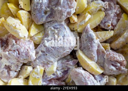 Hühnerscheiben werden vor dem Kochen mit Kartoffeln mariniert, Nahaufnahme im Vollformat Stockfoto