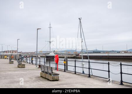 Drei Bänke rund um den Hafen von Rhyl, die im Herbst an der Küste von Nordwales zu sehen sind. Stockfoto