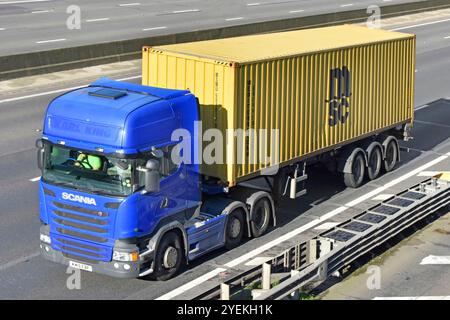 MSC-Versandcontainer auf Gelenkskelettanhänger, gezogen von blauem Fahrer der Marke Scania am Arbeitsplatz lkw-Lkw M25 Autobahn Essex England Großbritannien Stockfoto