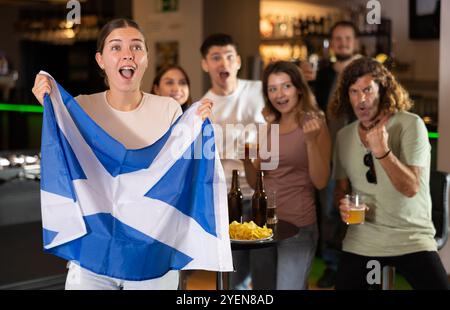 Gruppe von Fans in der Bar mit schottischer Flagge Stockfoto