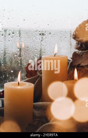 Hallo Herbst, feiern Herbstferien in gemütlichen Hause auf der Fensterbank Hygge Atmosphäre Thanksgiving Blätter, Gewürze und Kerze auf gemütlichen Strickpullover Stockfoto