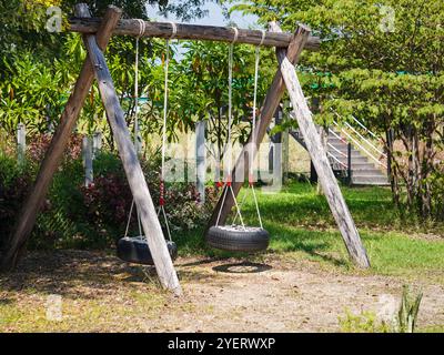 Reifenschaukel, hausgemachte Schaukel auf einem Spielplatz an einem Sommertag. Niemand auf der Reifenschaukel. Stockfoto