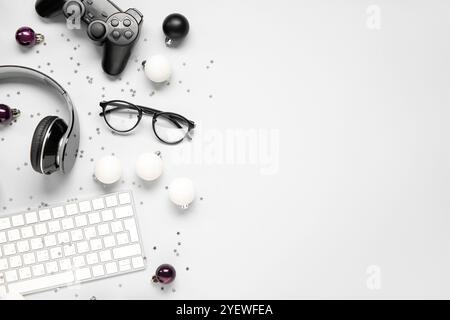 Komposition mit modernen Gadgets und Weihnachtsdekorationen auf hellem Hintergrund Stockfoto