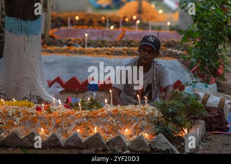 Dhaka, Bangladesch. November 2024. Ein Junge zündet Kerzen vor dem Grab seines Familienmitglieds an, anlässlich des Allerseelentages. Der All Sels Day wird von Christen gefeiert, die ihren verstorbenen Freunden und Verwandten Tribut zollen. Die Gräber sind wunderschön mit Blumen, Kerzen und Weihrauchstäbchen dekoriert. (Credit Image: © Sazzad Hossain/SOPA Images via ZUMA Press Wire) NUR REDAKTIONELLE VERWENDUNG! Nicht für kommerzielle ZWECKE! Quelle: ZUMA Press, Inc./Alamy Live News Stockfoto