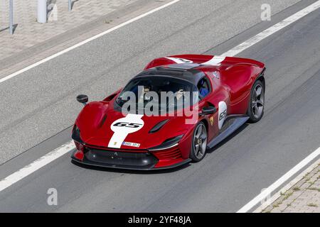 Nürburg, Deutschland - Blick auf einen roten Ferrari SP3, der auf einer Straße fährt. Stockfoto