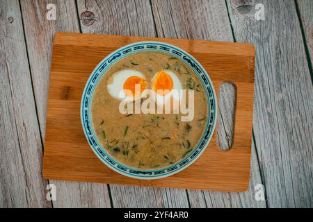Das Bild zeigt eine Schüssel mit traditioneller tschechischer Kulajda-Suppe mit cremiger Textur mit sichtbaren Pilzstücken, Kartoffeln und einem pochierten Ei Stockfoto