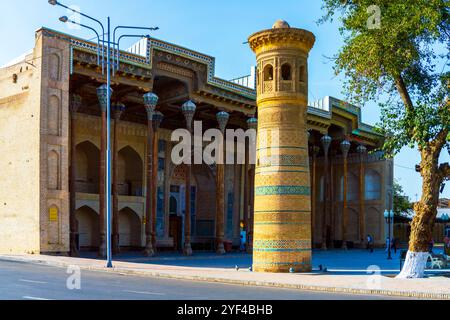 Straßenblick auf das Bolo Hauz Minaret und die Bolo Hauz Moschee. Fassade der Moschee mit Iwan auf der Rückseite, Säulen auf der Vorderseite mit Muqarnas dekoriert. Bukh Stockfoto