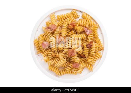 Fusilli Carbonara Nudeln mit knusprigen Speckstückchen und Parmesan auf einem Teller isoliert auf weißem Hintergrund. Stockfoto