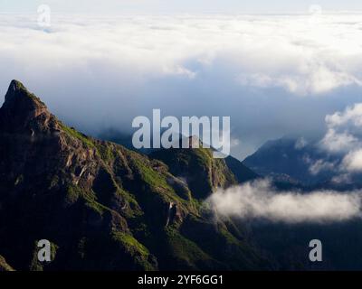 Ein dramatischer Berggipfel ragt in einen Wolkenhimmel, der einen atemberaubenden visuellen Effekt erzeugt, der das Auge zieht und ein Gefühl von Ehrfurcht und Wut weckt Stockfoto