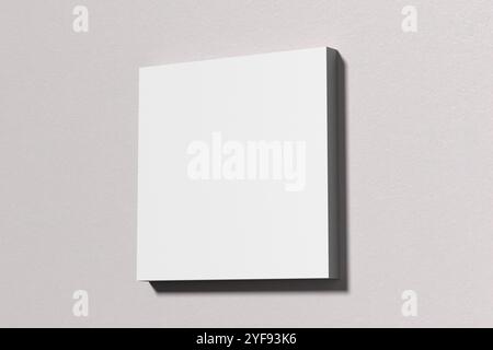 Minimalistische Komposition mit einer leeren weißen quadratischen Leinwand auf einer hellgrauen Wand, ideal für die Präsentation von Kunstwerken oder Designs. 3D-Rendering. Stockfoto