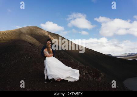 Hochzeitspaar, das in Island in der Nähe des Sees steht Stockfoto
