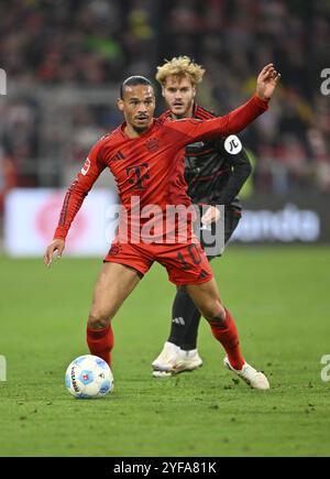 Tackle, Action Leroy Sane FC Bayern München FCB (10) gegen Yorbe Vertessen 1. FC Union Berlin FCU (07) Allianz Arena, München, Bayern, Deutschland, EUR Stockfoto