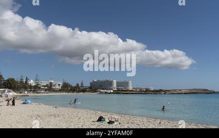 Ayia Napa, Zypern, 14. Februar 2021: Menschen ruhen und schwimmen am leeren tropischen Sandstrand. Nissi Beach Agia Napa, Zypern, Europa Stockfoto