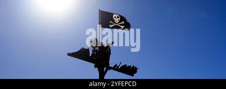 Jolly Roger Piratenfahne und Krähennest mit Sonnenfackeln, Barry Island, Vale of Glamorgan, Südwales, Großbritannien. Vom Oktober 2024. Herbst Stockfoto