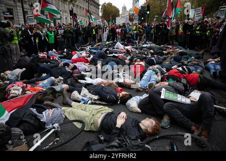 Die Menschenmassen beobachten, wie Hunderte an einem sterben in teilnehmen. Tausende nehmen an dem jüngsten Marsch für Palästina Teil, der in Zentral-London stattfand. Stockfoto